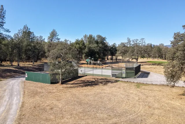 a view of a backyard with swimming pool