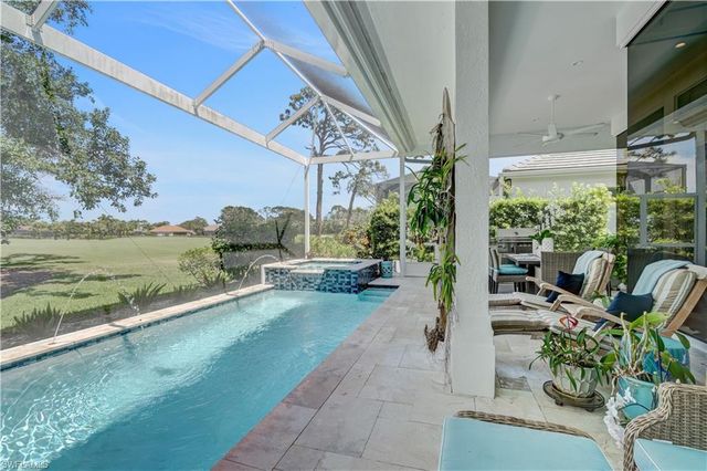 a view of a porch with furniture and a yard