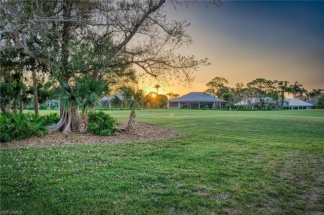 a view of a tree in front of a house