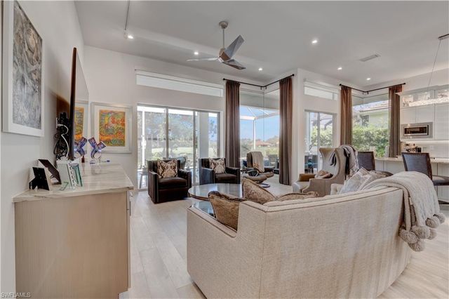 a view of living room with furniture large window and flat screen tv