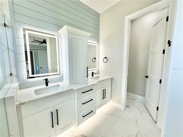 a bathroom with a double vanity sink and a mirror