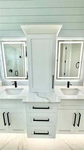 a bathroom with a sink vanity and a mirror