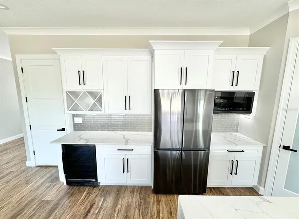 a kitchen with stainless steel appliances a refrigerator and a stove