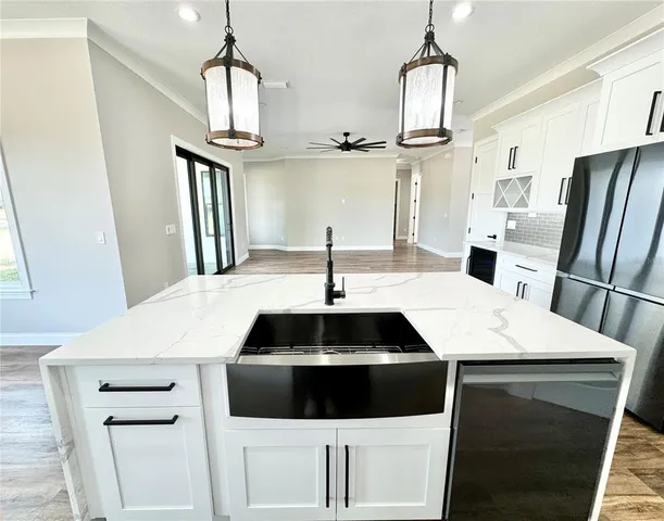 a kitchen with a sink dishwasher a stove and a refrigerator