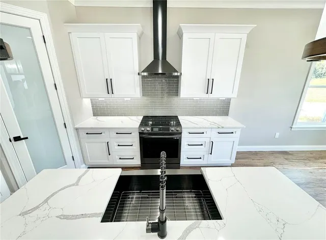a kitchen with a stove and cabinets
