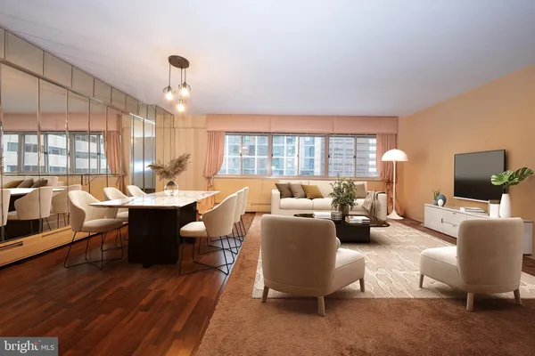 a living room with furniture flat screen tv and a large window