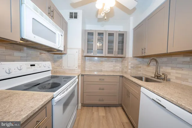 a kitchen with granite countertop cabinets stainless steel appliances and sink