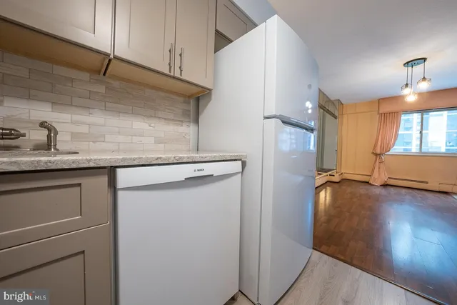 a kitchen with a sink and refrigerator