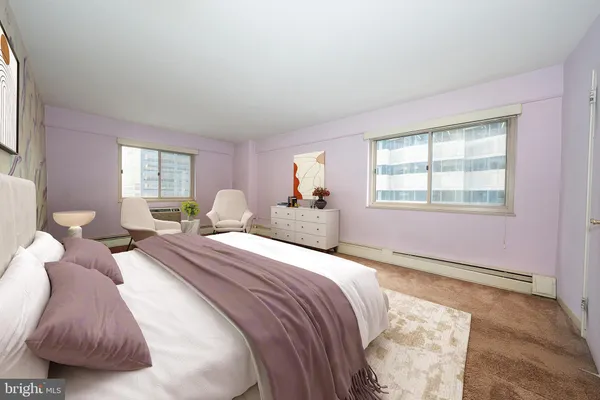 a bed room with two bed and a window