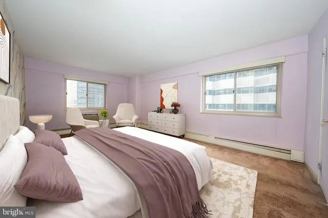 a bed room with two bed and a window