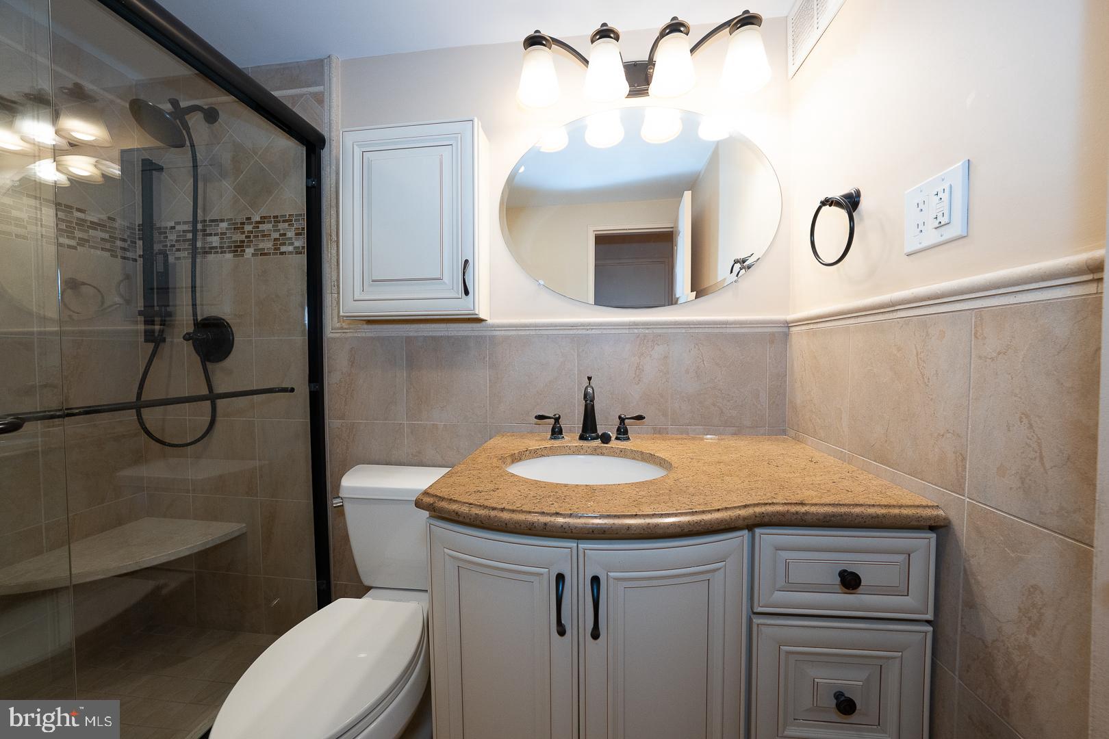 1900 John F Kennedy Boulevard, Unit 1012 Philadelphia, PA 19103 - Photo 7 of 22 a bathroom with a sink a toilet and mirror