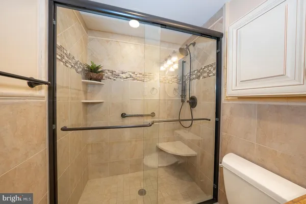 a bathroom with a toilet and a shower
