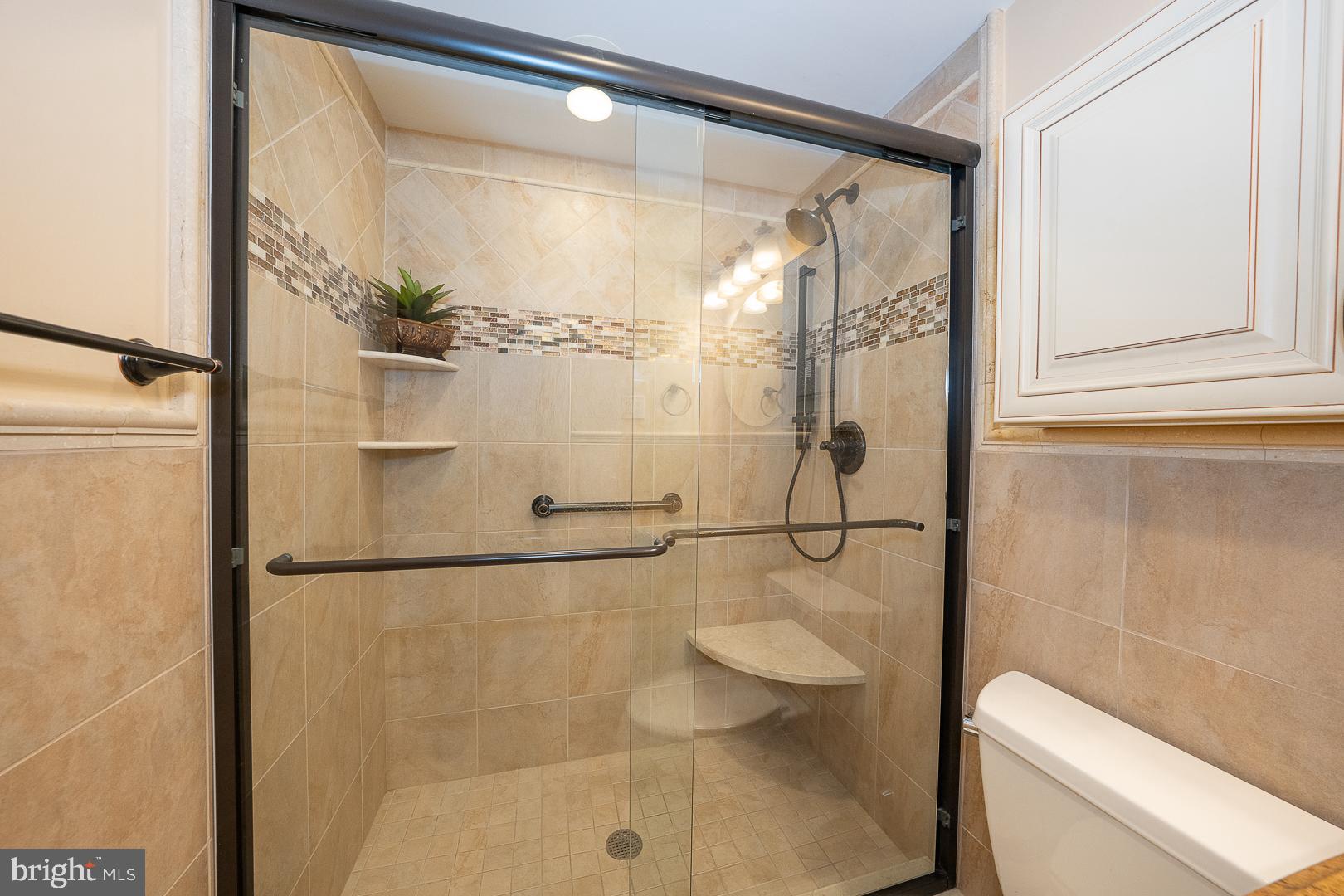 1900 John F Kennedy Boulevard, Unit 1012 Philadelphia, PA 19103 - Photo 9 of 22 a bathroom with a toilet and a shower