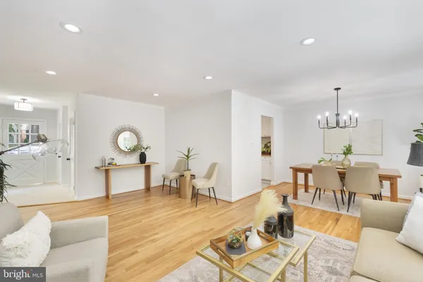 a living room with furniture a dining table and kitchen view