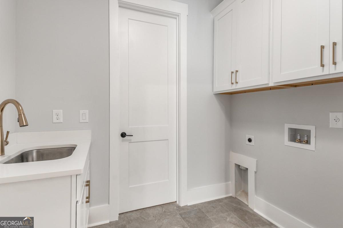 229 Eagles Way Eatonton, GA 31024 - Photo 26 of 61 a kitchen with white cabinets and sink