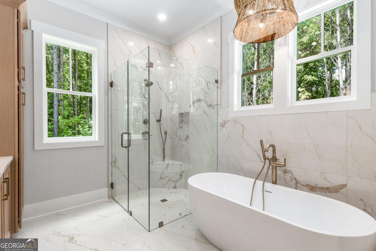 229 Eagles Way Eatonton, GA 31024 - Photo 31 of 61 a bathroom with a tub and a shower