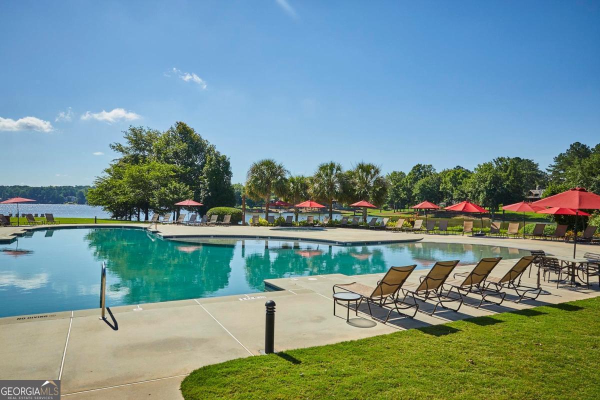 229 Eagles Way Eatonton, GA 31024 - Photo 48 of 61 a view of a lake with a bench in a patio