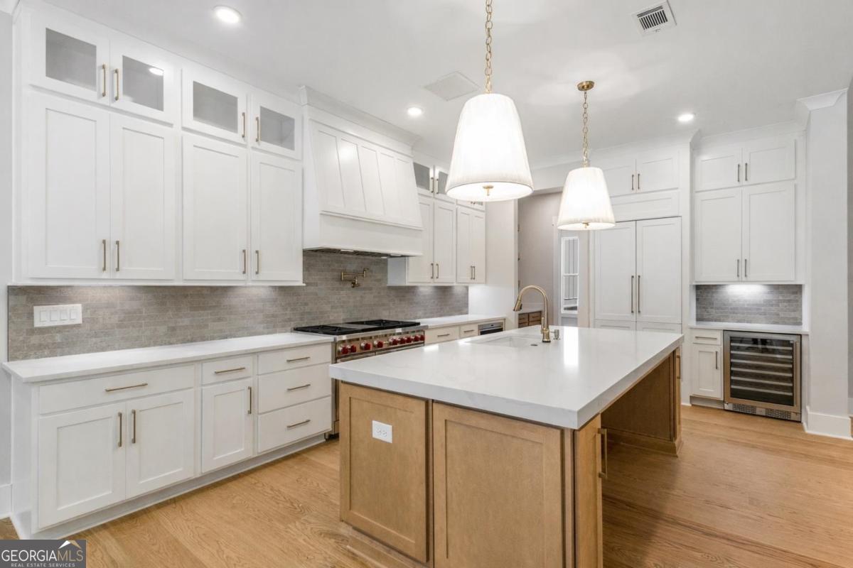 229 Eagles Way Eatonton, GA 31024 - Photo 6 of 61 a kitchen with kitchen island a stove a sink a center island and cabinets