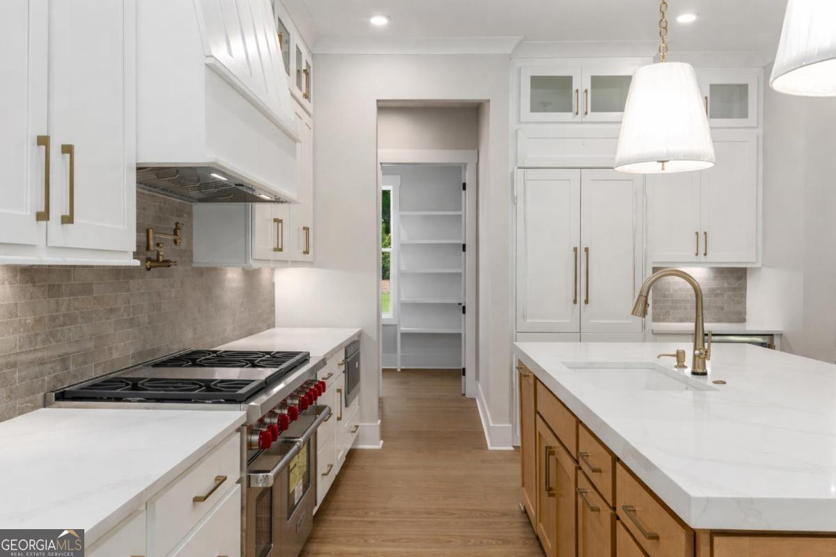 229 Eagles Way Eatonton, GA 31024 - Photo 7 of 61 a kitchen with a sink a stove and a refrigerator