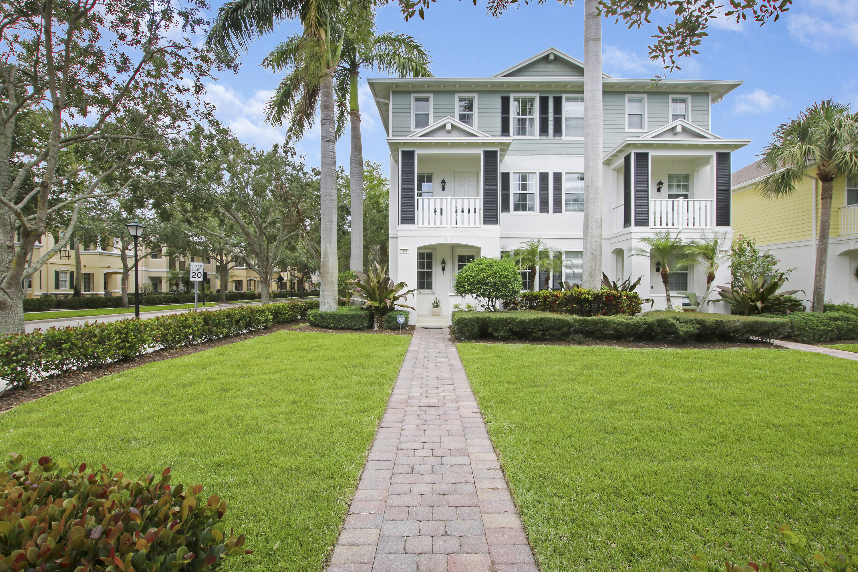 3424 West Community Drive Jupiter, FL 33458 - Photo 20 of 25 front view of a brick house with a yard