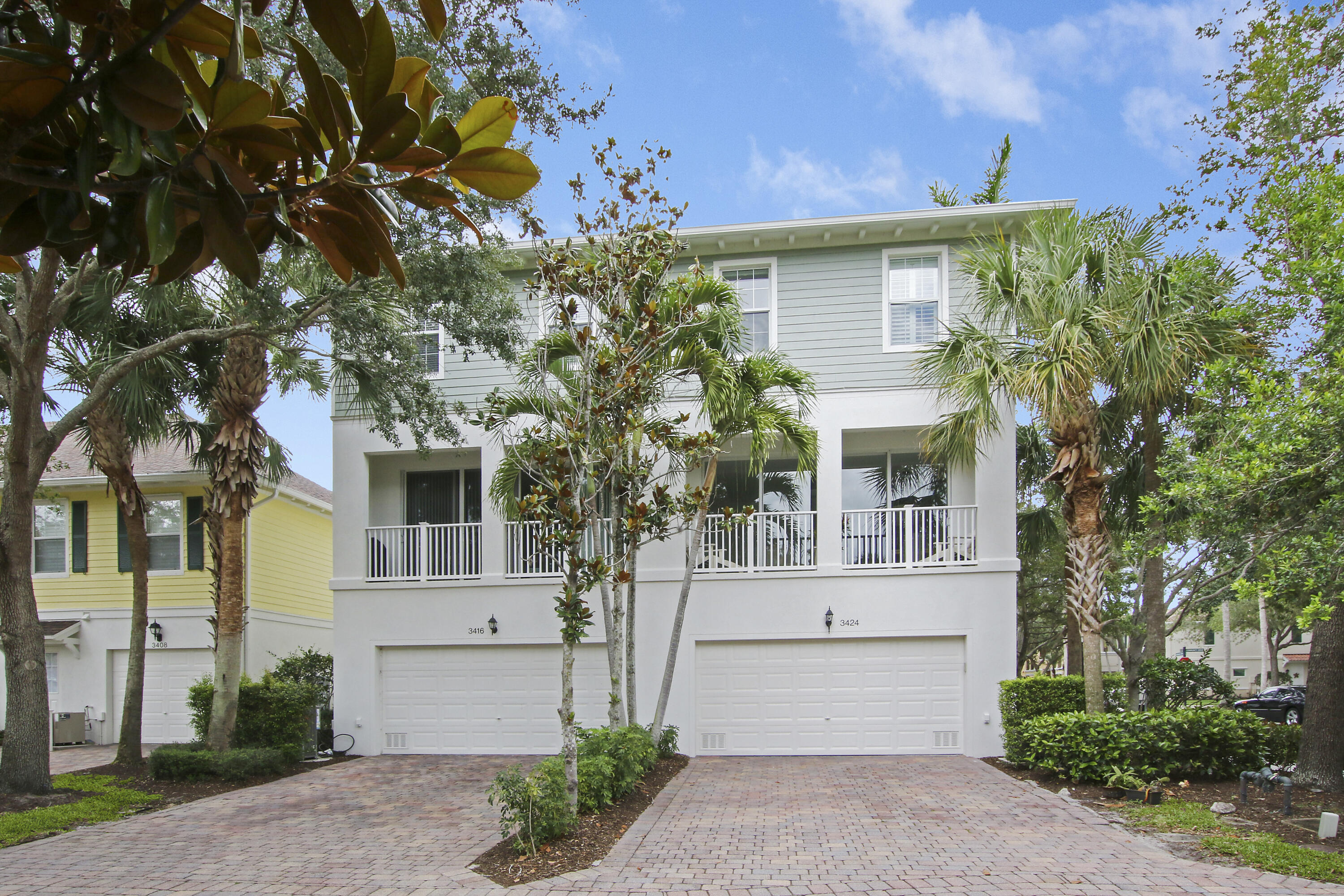 3424 West Community Drive Jupiter, FL 33458 - Photo 24 of 25 a front view of a house with a garden