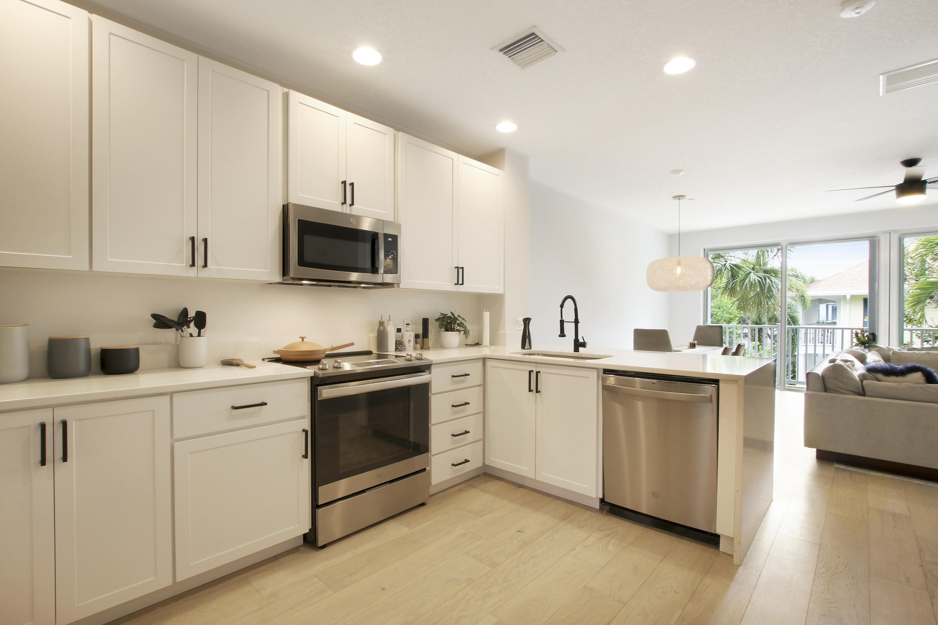 3424 West Community Drive Jupiter, FL 33458 - Photo 25 of 25 a kitchen with white cabinets and white appliances