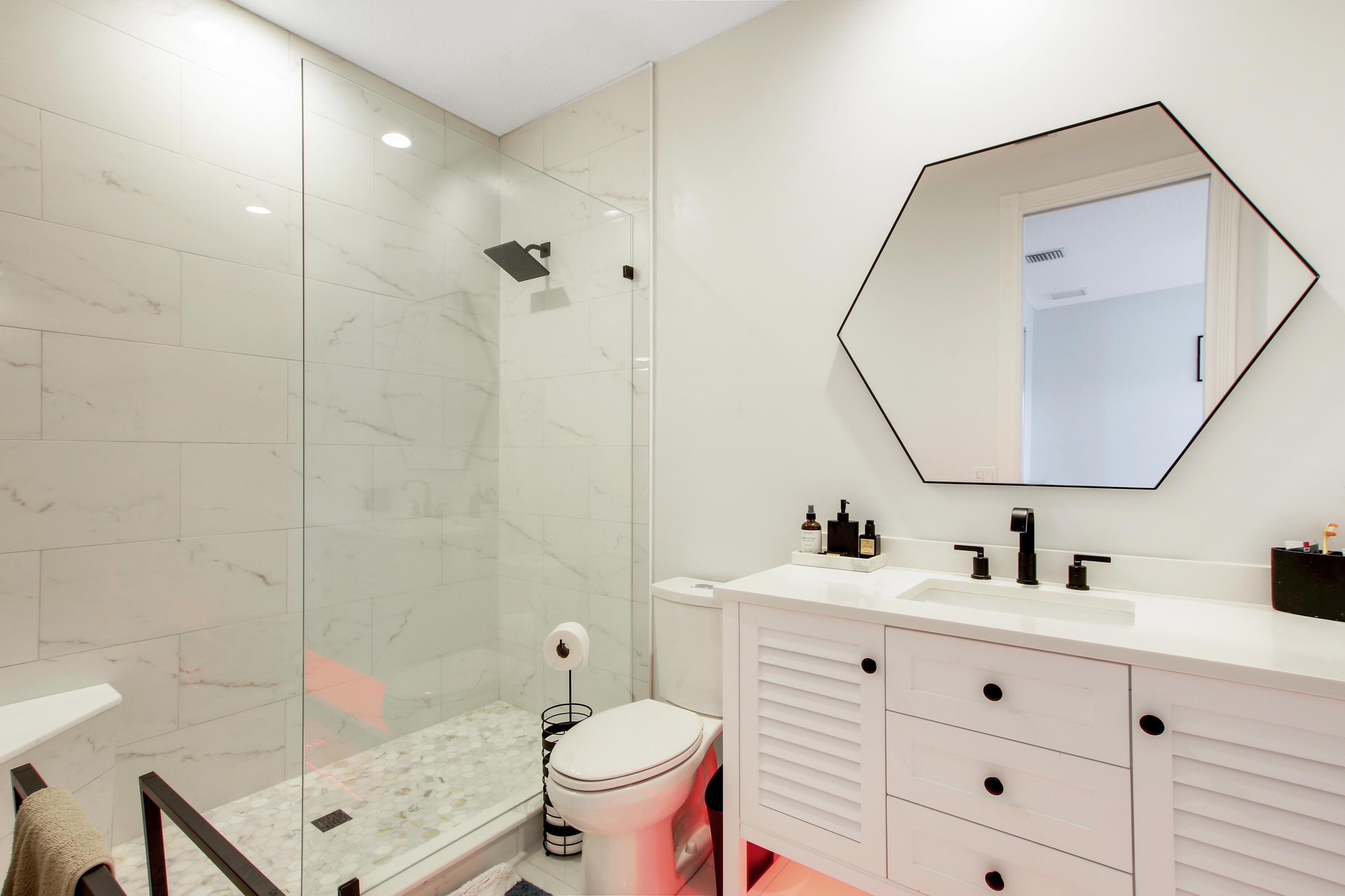 3424 West Community Drive Jupiter, FL 33458 - Photo 10 of 25 a bathroom with a sink mirror toilet and shower