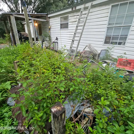 a backyard of a house with table and chairs