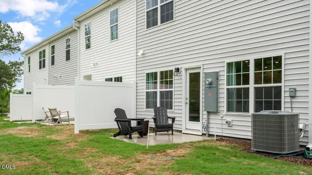 a view of a house with backyard and sitting area
