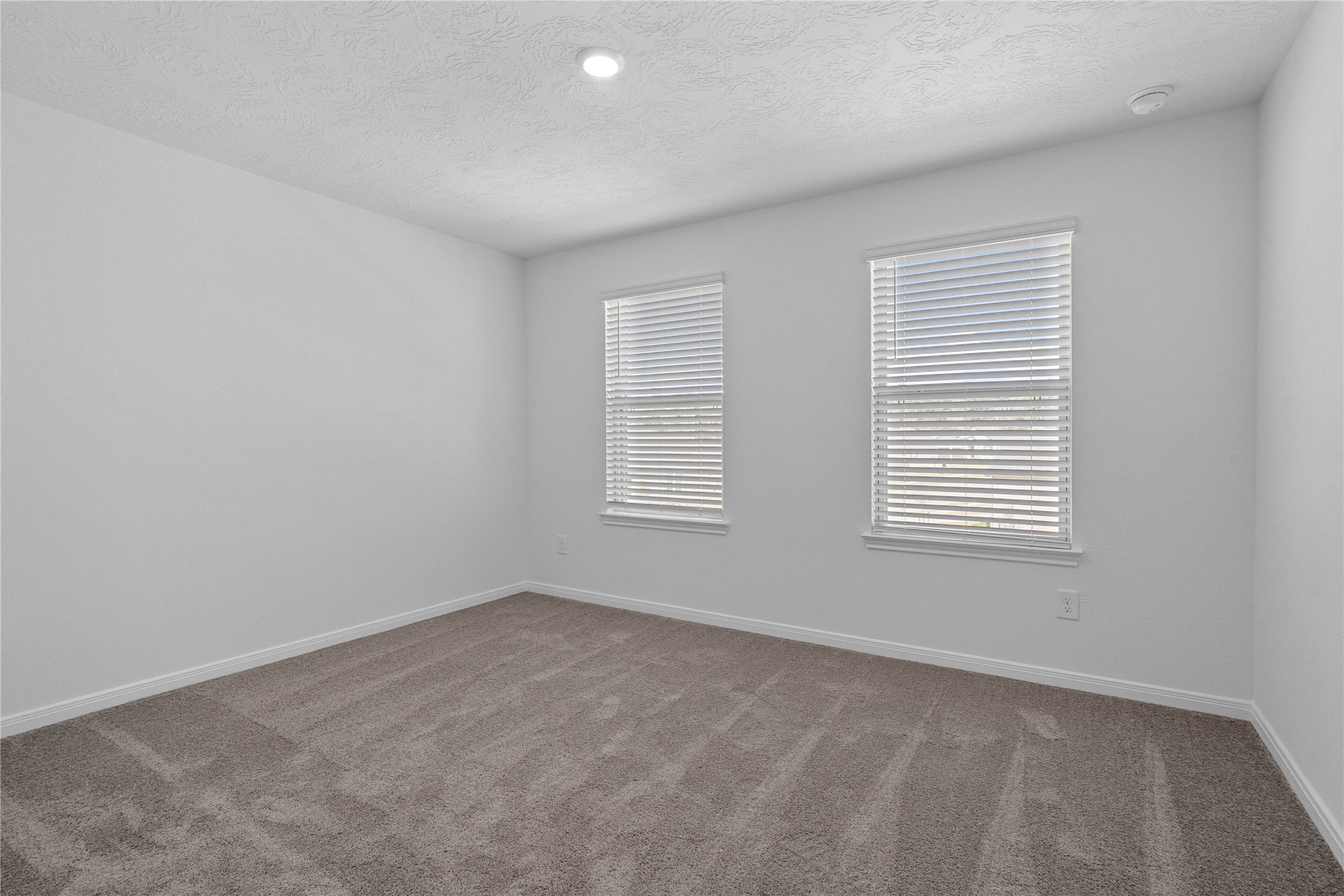 25503 Alpine Switchback Drive Spring, TX 77373 - Photo 22 of 32 Secondary bedroom features plush carpet, neutral paint, recessed lighting, windows with blinds, and closet space.
