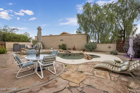 a view of a patio with a table and chairs