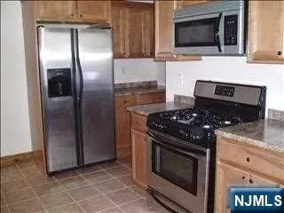 a kitchen with a stove microwave and refrigerator