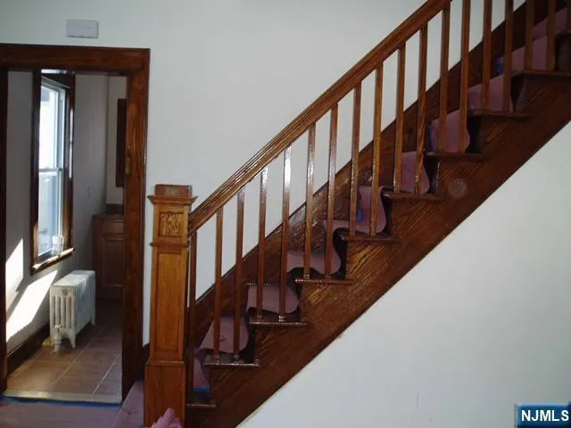 a view of entryway with wooden floor and a front door