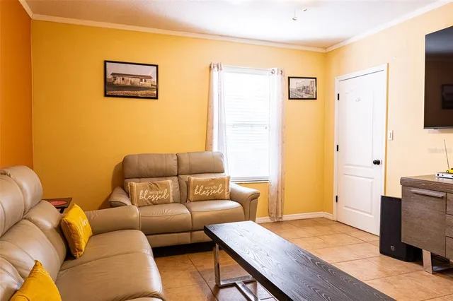 a bedroom with a bed and a lamp on dresser