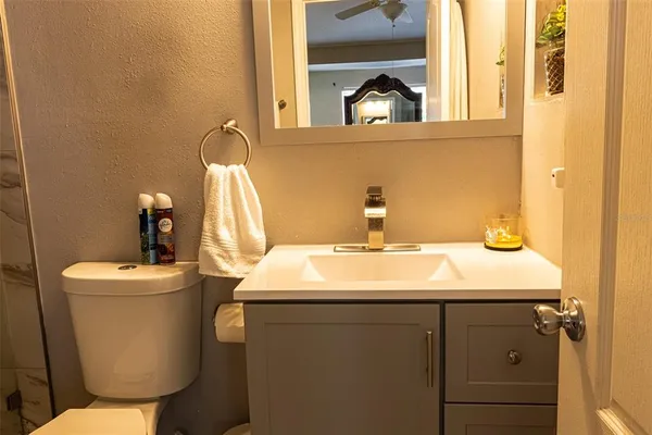 a bathroom with a toilet sink and mirror
