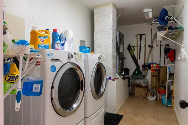 a utility room with dryer washer and other items
