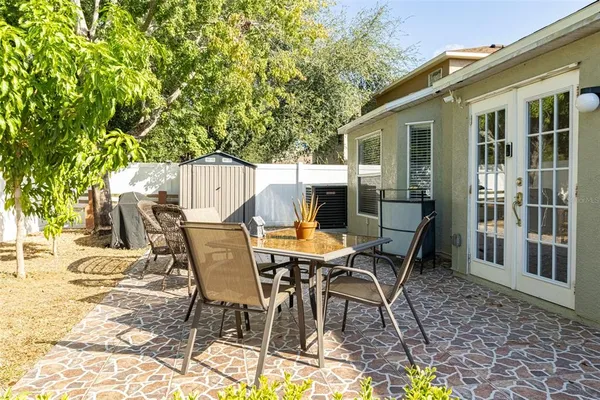 a view of a patio with a table and chairs