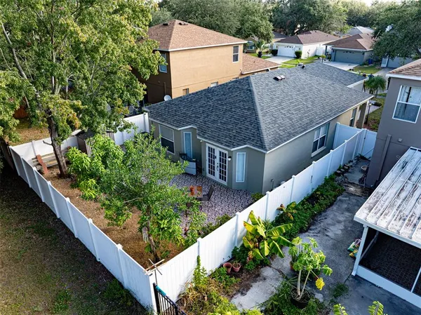 an aerial view of a house with a yard