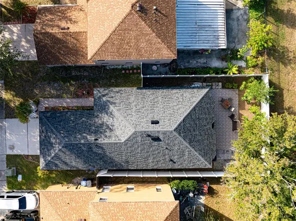 a aerial view of a house with large trees