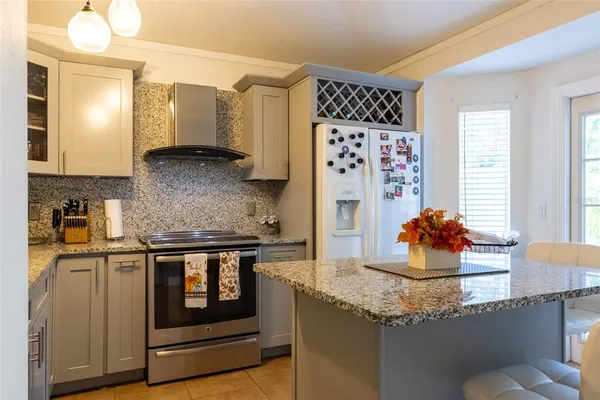 a kitchen with stainless steel appliances granite countertop a stove and a refrigerator