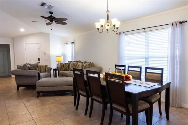 a view of a dining room with furniture and a chandelier