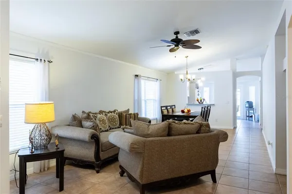 a living room with furniture and a chandelier
