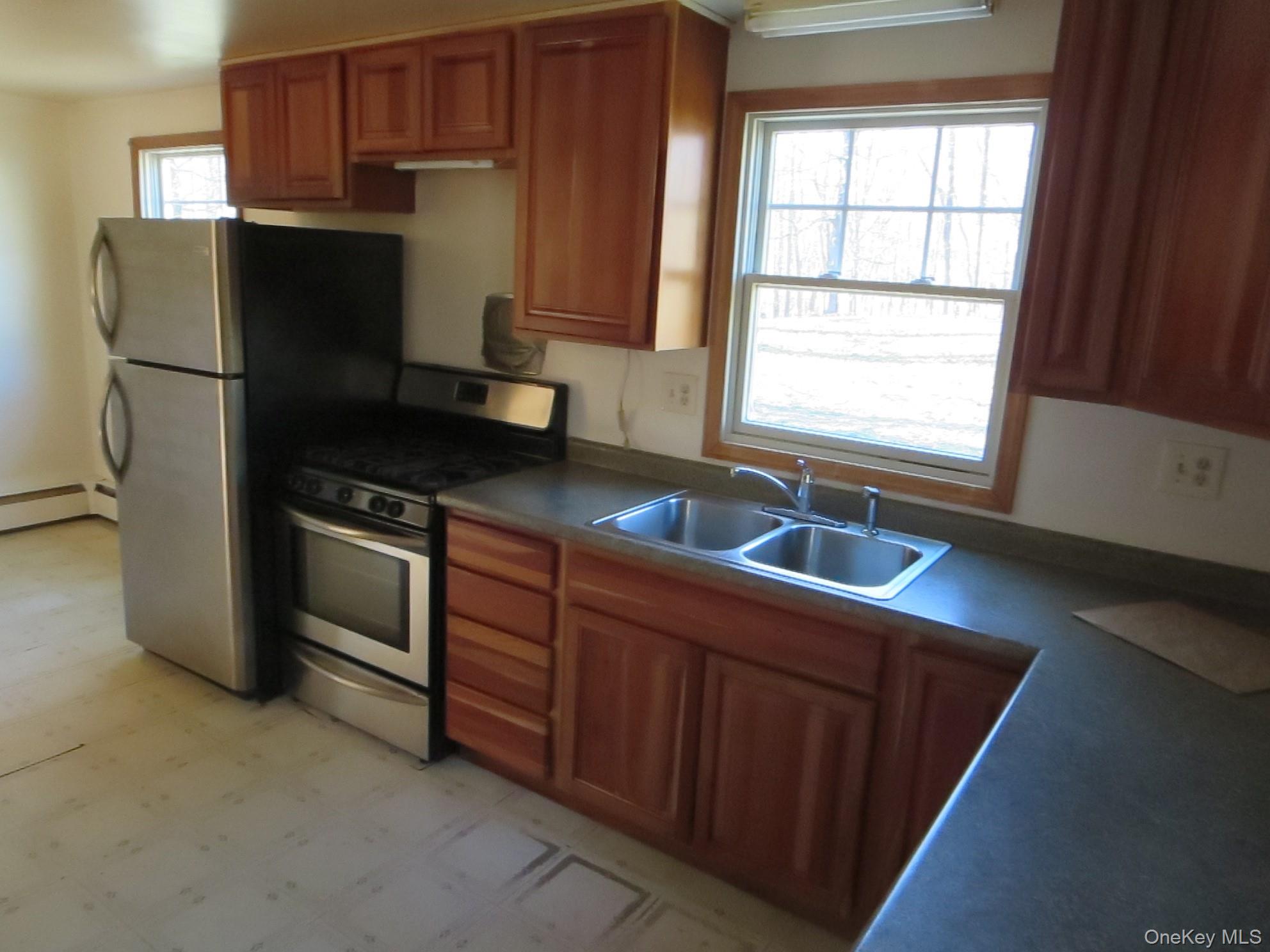 3057 Pleasant Ridge Road Wingdale, NY 12594 - Photo 6 of 13 a kitchen with granite countertop a refrigerator and a sink