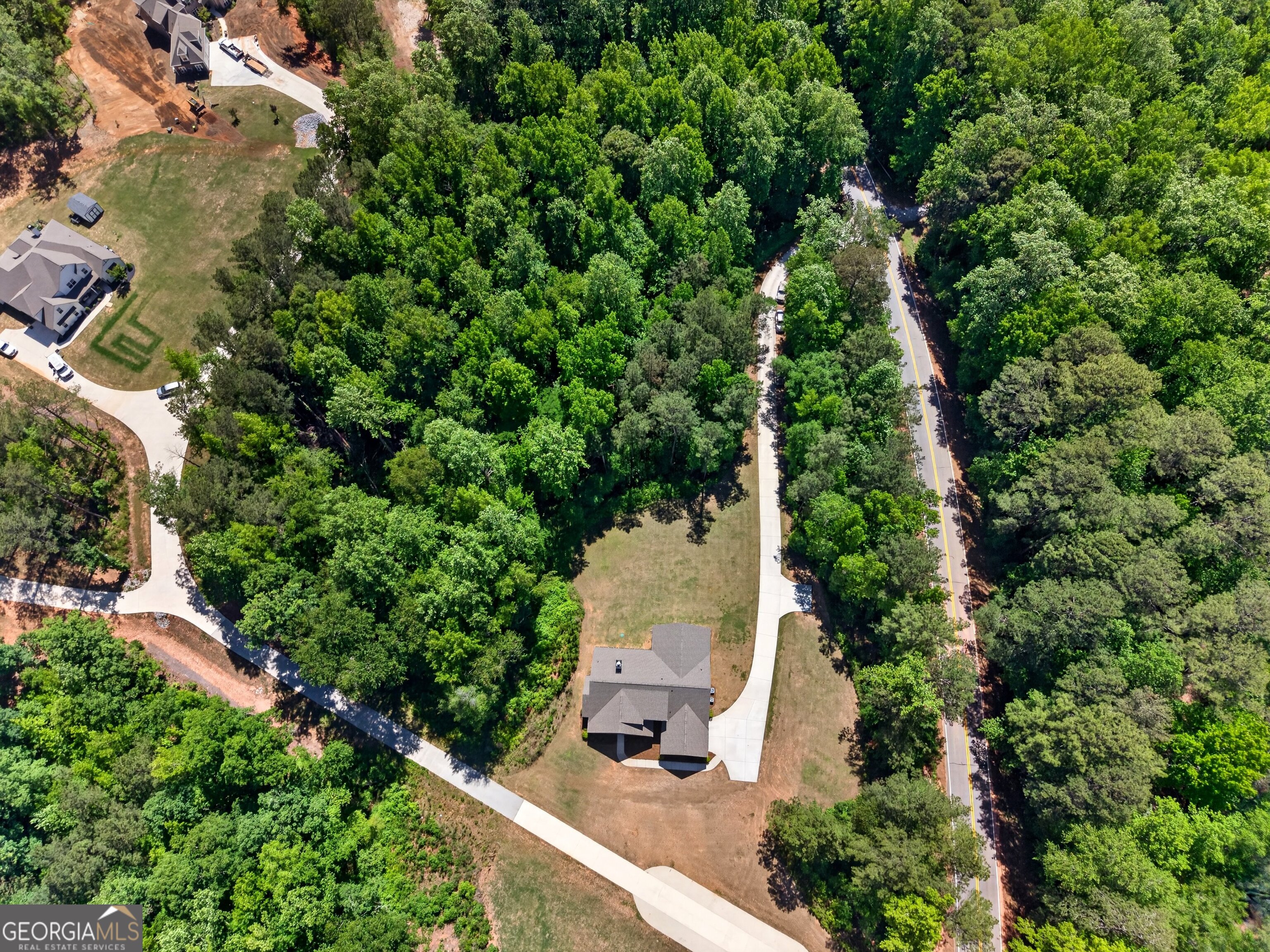 1764 Luther Bailey Road Senoia, GA 30276 - Photo 61 of 63 an aerial view of a house with a yard and covered with trees