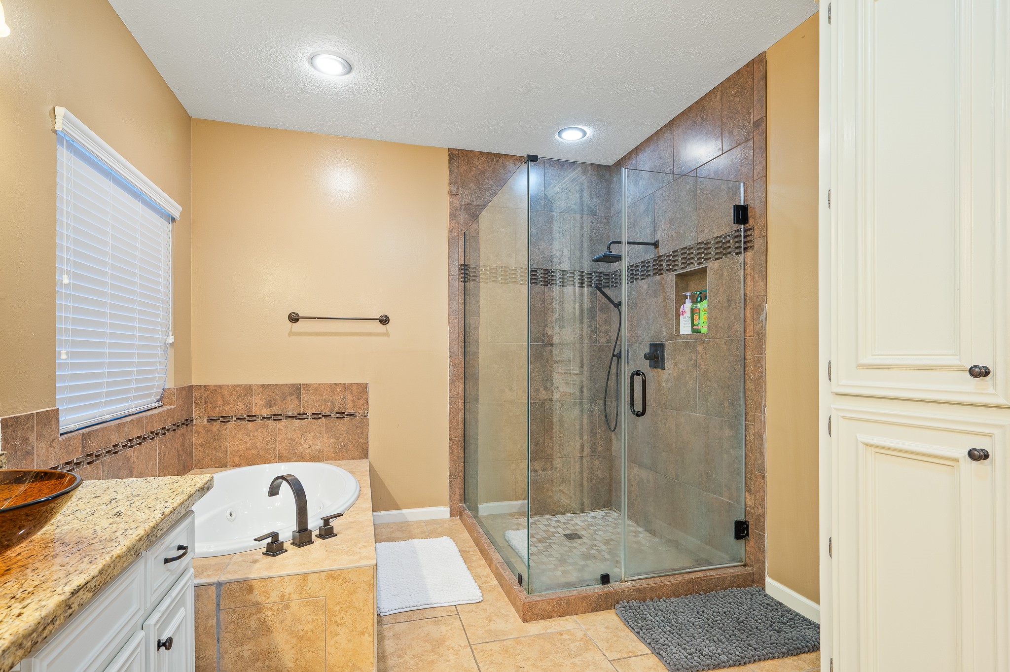 8111 Morningbrook Court Spring, TX 77379 - Photo 24 of 46 a bathroom with a tub shower sink and mirror