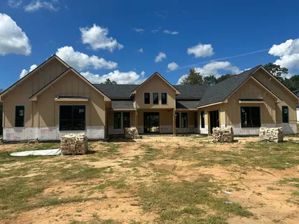 a view of a house with a swimming pool and sitting area