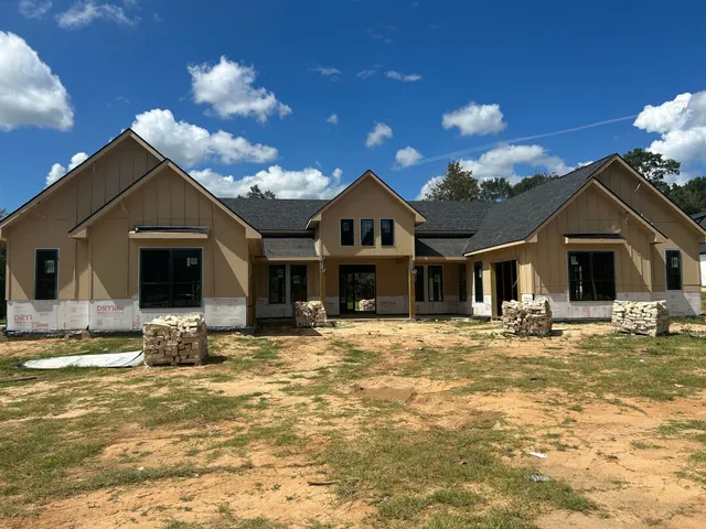 a view of a house with a swimming pool and sitting area