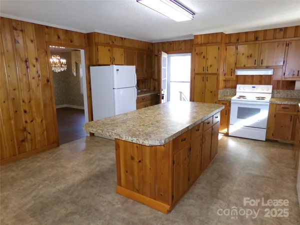 a kitchen with refrigerator and stove