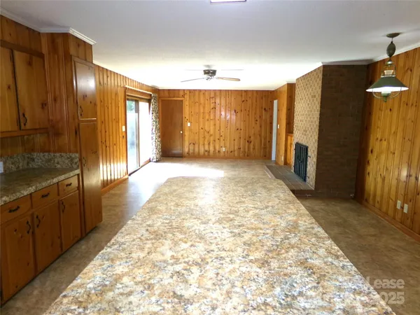 a view of hallway with granite countertop furniture and a fireplace