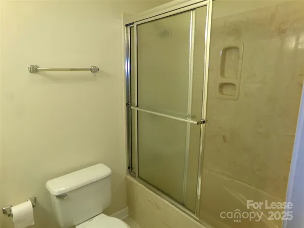 a bathroom with a shower and a toilet
